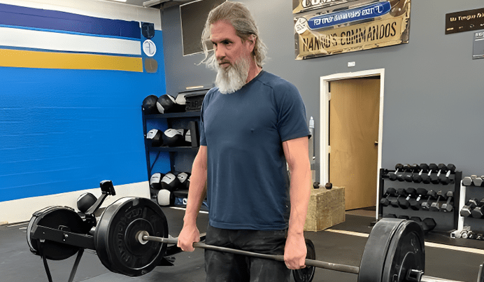 Scott Lofquist lifting a barbell in the gym